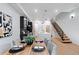 Open kitchen and dining area with modern fixtures, stainless appliances, and floating stairs to the upper level at 2010 Pearl St # B, Boulder, CO 80302