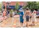 A community splash pad with children playing in water jets under the sunshine in a vibrant public space at 2010 Pearl St # B, Boulder, CO 80302