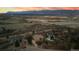 Panoramic aerial view of a home with stunning city and mountain views at twilight at 265 Ox Yoke Way, Monument, CO 80132
