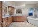 Bright bathroom features a soaking tub, beautiful mountain view, and custom wood cabinets at 265 Ox Yoke Way, Monument, CO 80132
