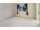 Neutral bedroom with large window and dark curtains, offering natural light at 265 Ox Yoke Way, Monument, CO 80132
