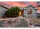 Charming front entrance with a decorative walkway, mature landscaping, and arched window at 265 Ox Yoke Way, Monument, CO 80132