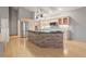Updated kitchen boasts stainless appliances, island with stone accent, and plenty of cabinet space at 265 Ox Yoke Way, Monument, CO 80132