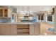 Spacious kitchen with custom cabinets, modern appliances, stone accents, and stunning mountain views at 265 Ox Yoke Way, Monument, CO 80132