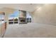 Bright living room featuring a stone fireplace, large windows with mountain views, and neutral carpet at 265 Ox Yoke Way, Monument, CO 80132