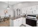 Cozy kitchen features granite countertops, white cabinets, and breakfast nook at 5095 S Newcombe Ct, Littleton, CO 80127