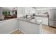View of kitchen with stainless steel appliances, granite countertops, and connection to living area at 5095 S Newcombe Ct, Littleton, CO 80127