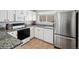 Bright kitchen features granite countertops, stainless steel refrigerator, and white cabinetry at 5095 S Newcombe Ct, Littleton, CO 80127