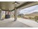 Covered back patio with a grill and a view of the backyard, the shed and the hills at 11020 E 150Th Pl, Brighton, CO 80602