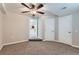Spacious carpeted basement room featuring neutral walls, a ceiling fan, and closet storage space at 11020 E 150Th Pl, Brighton, CO 80602
