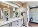 Large bathroom featuring double sinks, modern fixtures, and a separate glass enclosed shower at 11020 E 150Th Pl, Brighton, CO 80602
