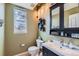 Charming powder room with decorative shelves and a window offering natural light at 11020 E 150Th Pl, Brighton, CO 80602