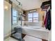 Bright bathroom with a soaking tub, separate shower and a window with a view at 11020 E 150Th Pl, Brighton, CO 80602