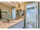 Well-lit bathroom featuring double sinks, modern fixtures, and a separate toilet area at 11020 E 150Th Pl, Brighton, CO 80602