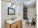 Traditional bathroom with a vanity and a shower and tub combination with decorative floral wallpaper at 11020 E 150Th Pl, Brighton, CO 80602