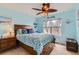 Bright bedroom with a wooden bed frame, decorative pillows, and a ceiling fan at 11020 E 150Th Pl, Brighton, CO 80602