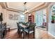 Stylish dining room with hardwood floors, modern lighting, and views of the surrounding landscape at 11020 E 150Th Pl, Brighton, CO 80602