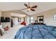 A generous main bedroom suite includes sitting area, ceiling fan, and large windows at 11020 E 150Th Pl, Brighton, CO 80602