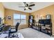 Home office featuring a ceiling fan, large window, and ample storage space at 11020 E 150Th Pl, Brighton, CO 80602