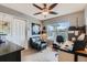 Well-lit home office with a ceiling fan, large window, and comfortable seating at 11020 E 150Th Pl, Brighton, CO 80602