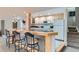 The basement wet bar features seating for three, light wood cabinetry and a marble countertop at 11020 E 150Th Pl, Brighton, CO 80602