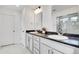 Elegant bathroom with double sinks, and a sleek glass enclosed shower at 4407 N Quemoy St, Aurora, CO 80019