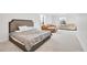Spacious carpeted bedroom featuring a comfortable bed and ample seating area, perfect for relaxation and restful nights at 4407 N Quemoy St, Aurora, CO 80019