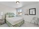 Charming bedroom with floral headboard, neutral walls and bright window at 4407 N Quemoy St, Aurora, CO 80019