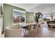 Stylish dining room with hardwood floors, a large window, and seamless flow into the living area at 4407 N Quemoy St, Aurora, CO 80019