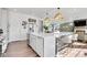 Bright kitchen features a large island with bar seating and modern light fixtures at 4407 N Quemoy St, Aurora, CO 80019
