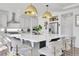 Modern kitchen featuring a spacious island with seating, stainless steel appliances, and contemporary pendant lights at 4407 N Quemoy St, Aurora, CO 80019