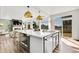 Open kitchen boasts a large island, stainless steel appliances and oversized windows at 4407 N Quemoy St, Aurora, CO 80019