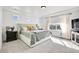 Bright main bedroom with tray ceilings, large windows, and neutral decor at 4407 N Quemoy St, Aurora, CO 80019