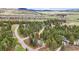 Scenic aerial view of a home nestled amongst lush trees in a mountain community, with the property line highlighted at 4185 Cheyenne Dr, Larkspur, CO 80118