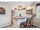Charming bar area with custom shelves and countertops with bar seating at 4185 Cheyenne Dr, Larkspur, CO 80118