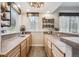 Wet bar area with lots of counterspace, wine fridge, sink and custom wood shelving at 4185 Cheyenne Dr, Larkspur, CO 80118