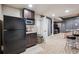 Finished basement with bar area featuring cabinetry, countertop, microwave, and bar seating at 4185 Cheyenne Dr, Larkspur, CO 80118