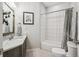 Bathroom with single sink vanity, tile flooring, and bathtub shower at 4185 Cheyenne Dr, Larkspur, CO 80118
