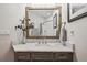 Bathroom with marble countertop and vanity, framed mirror, and decorative accents at 4185 Cheyenne Dr, Larkspur, CO 80118