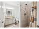 Updated bathroom featuring granite vanity, neutral paint, and tiled shower with shower curtain at 4185 Cheyenne Dr, Larkspur, CO 80118