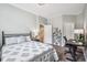 Cozy bedroom with tile floors, a decorative metal bed frame, and access to stairs at 4185 Cheyenne Dr, Larkspur, CO 80118