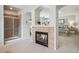 Bedroom featuring a dual fireplace, walk-in shower, and relaxing ambiance at 4185 Cheyenne Dr, Larkspur, CO 80118