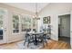 Dining area features a round table, chandelier, and large windows at 4185 Cheyenne Dr, Larkspur, CO 80118