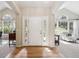 Inviting foyer with hardwood floors, arched entryways, natural light, and detailed trim work at 4185 Cheyenne Dr, Larkspur, CO 80118
