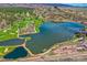 Expansive aerial view showcasing a golf course, tranquil lake, and picturesque surroundings at 4185 Cheyenne Dr, Larkspur, CO 80118
