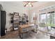 Bright office space featuring custom desk, shelving, and sliding glass door to backyard at 4185 Cheyenne Dr, Larkspur, CO 80118