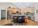 Open concept kitchen featuring a large kitchen island with seating, light cabinets, and stainless steel appliances at 4185 Cheyenne Dr, Larkspur, CO 80118