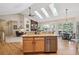Bright kitchen with island, granite counters, and stainless steel appliances at 4185 Cheyenne Dr, Larkspur, CO 80118