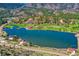 Stunning aerial view of a lake surrounded by mountains, trees, and golf course at 4185 Cheyenne Dr, Larkspur, CO 80118