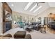 Living room showcasing stone fireplace, vaulted ceilings, and bright, natural light at 4185 Cheyenne Dr, Larkspur, CO 80118